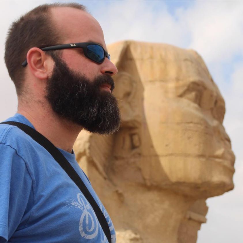 Me in front of the Sphynx An absurdly good looking bearded man stares out in the distance as the mysterious Sphynx does the same, wondering what I'm looking at